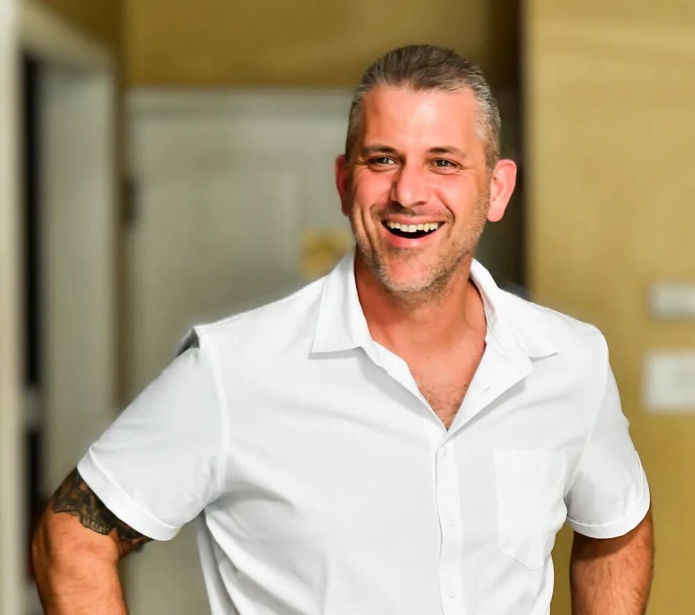 Brian, owner of BN Exteriors, smiling in a white shirt