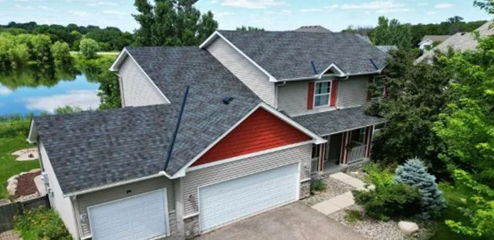 Lakefront home with newly installed charcoal dimensional asphalt shingles