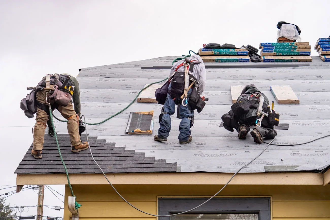 Roofing crew working along a ridge