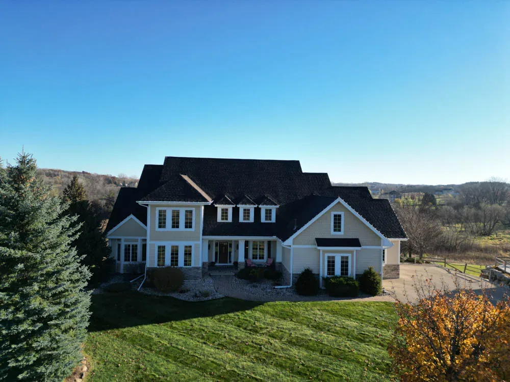 Large two-story home with a new dark architectural shingle roof