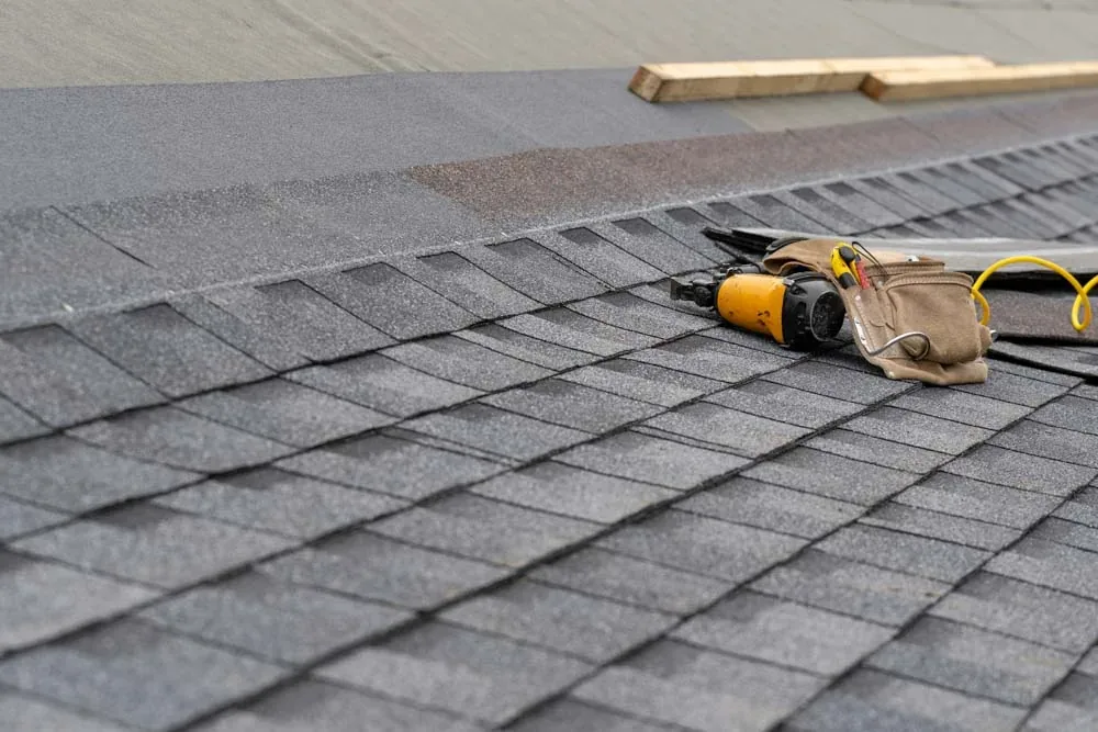 Close-up of new asphalt shingles being installed
